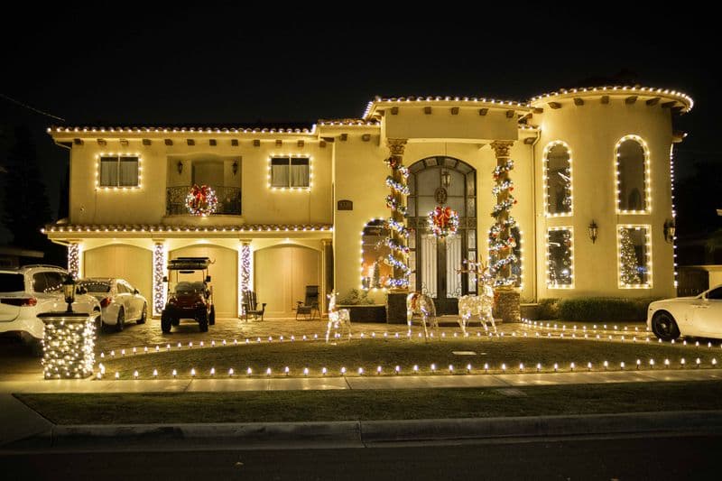 Southern California home with a professional warm white holiday light display