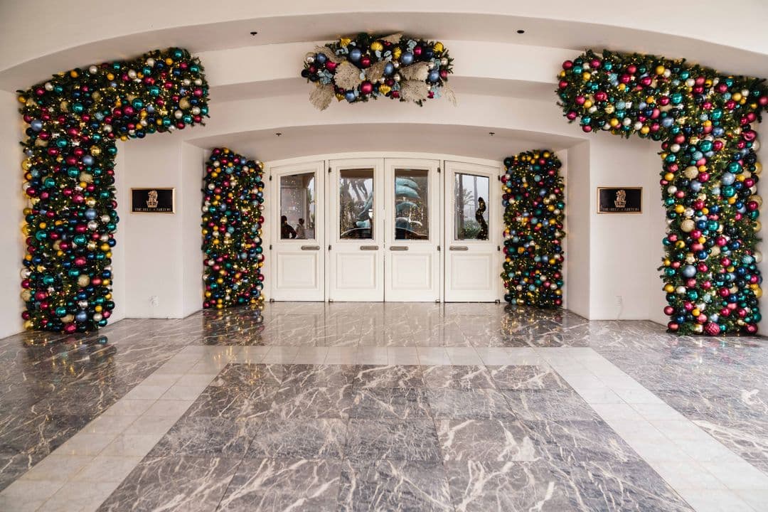 Colorful ornament garlands framing the entrance to a commercial hospitality property