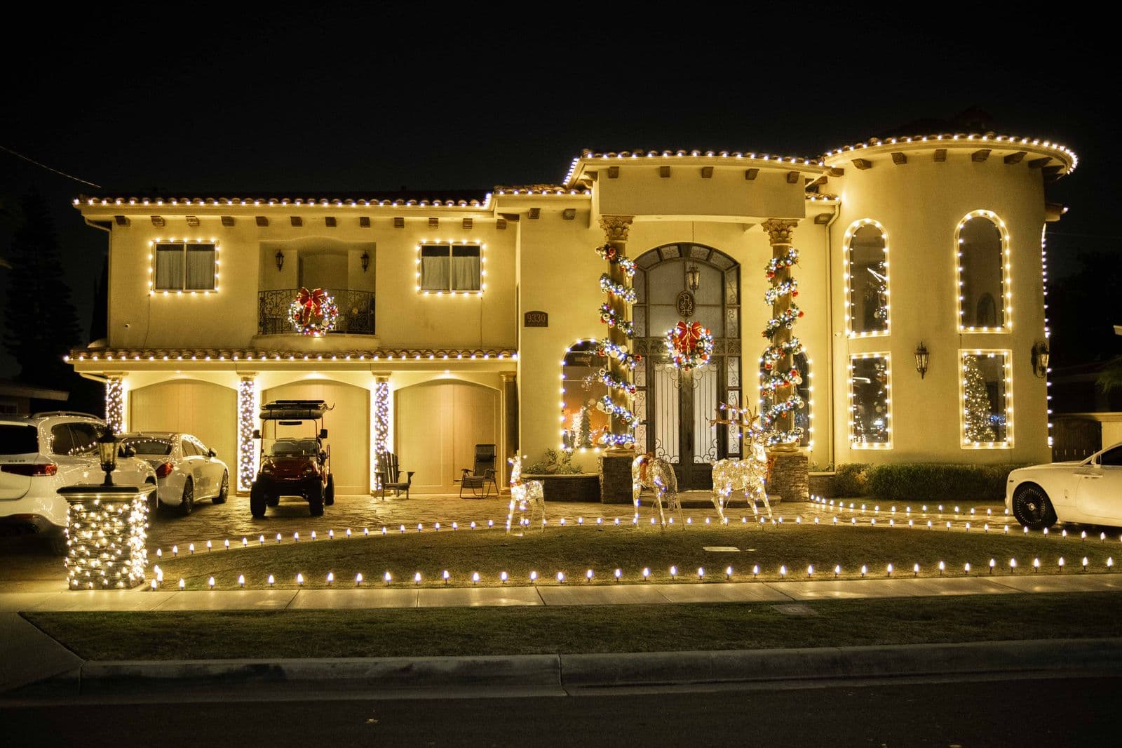 Large Southern California home with a professionally installed warm-white Christmas lighting display