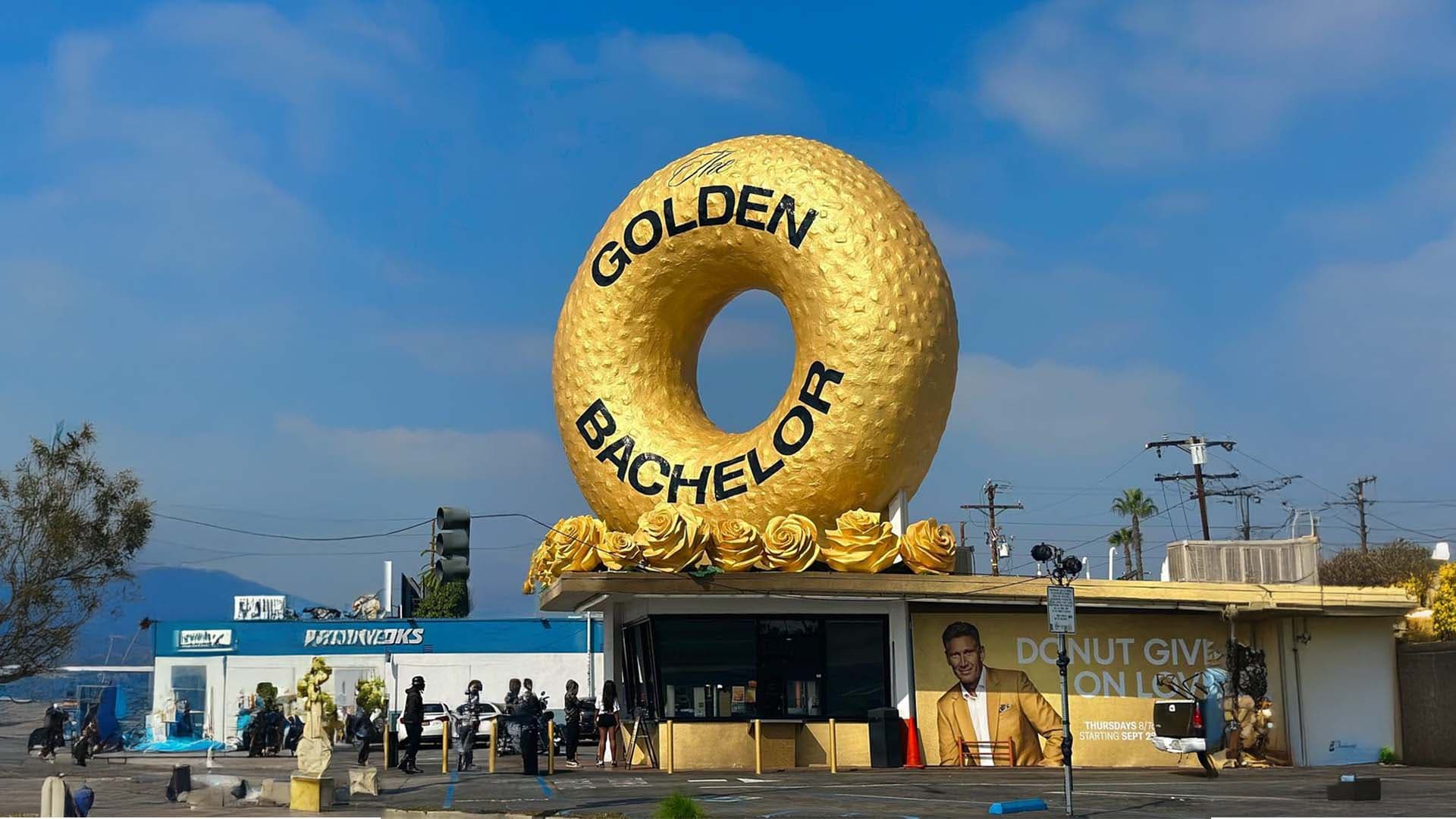 Golden Bachelor experiential installation with a giant gold donut