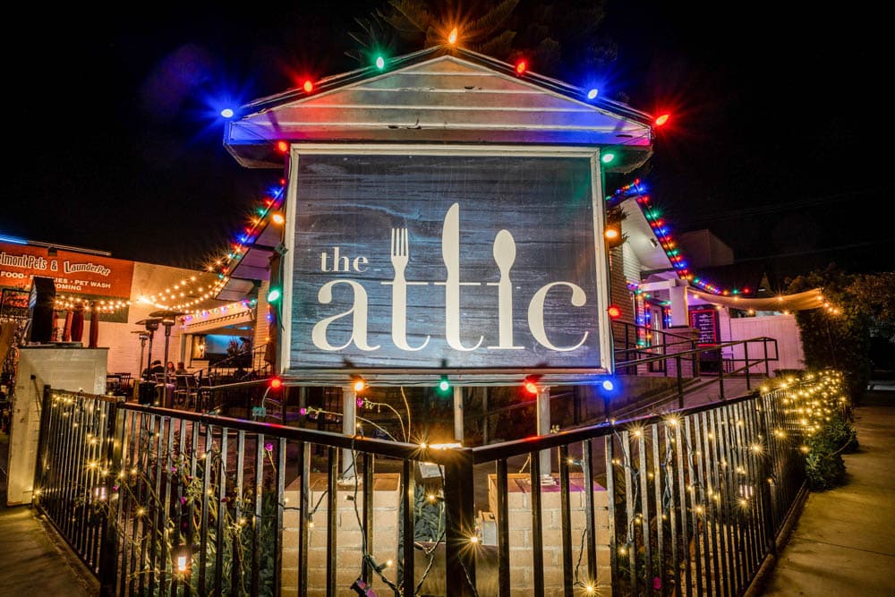 The Attic restaurant exterior illuminated with colorful holiday lighting