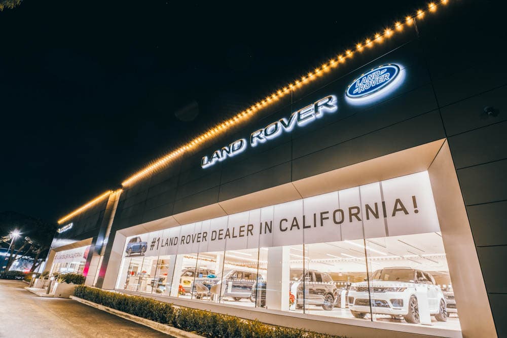 Land Rover dealership showroom outlined with warm white holiday lights