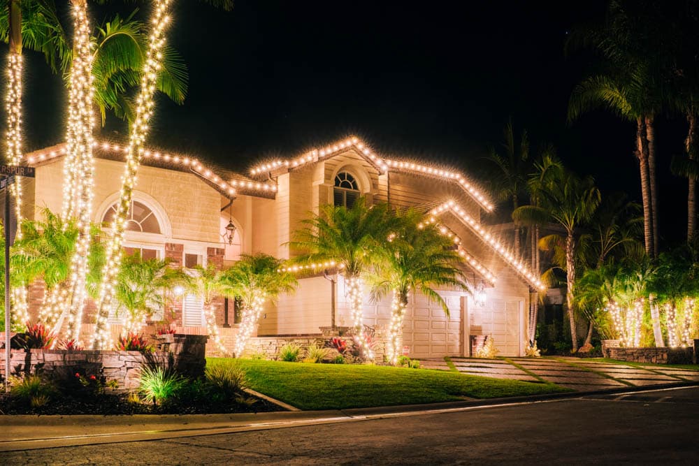 Residential property outlined with warm white holiday lighting