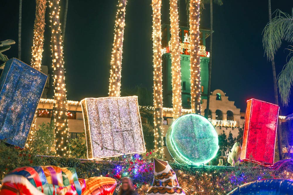Oversized illuminated candy sculptures in a palm-lined public destination
