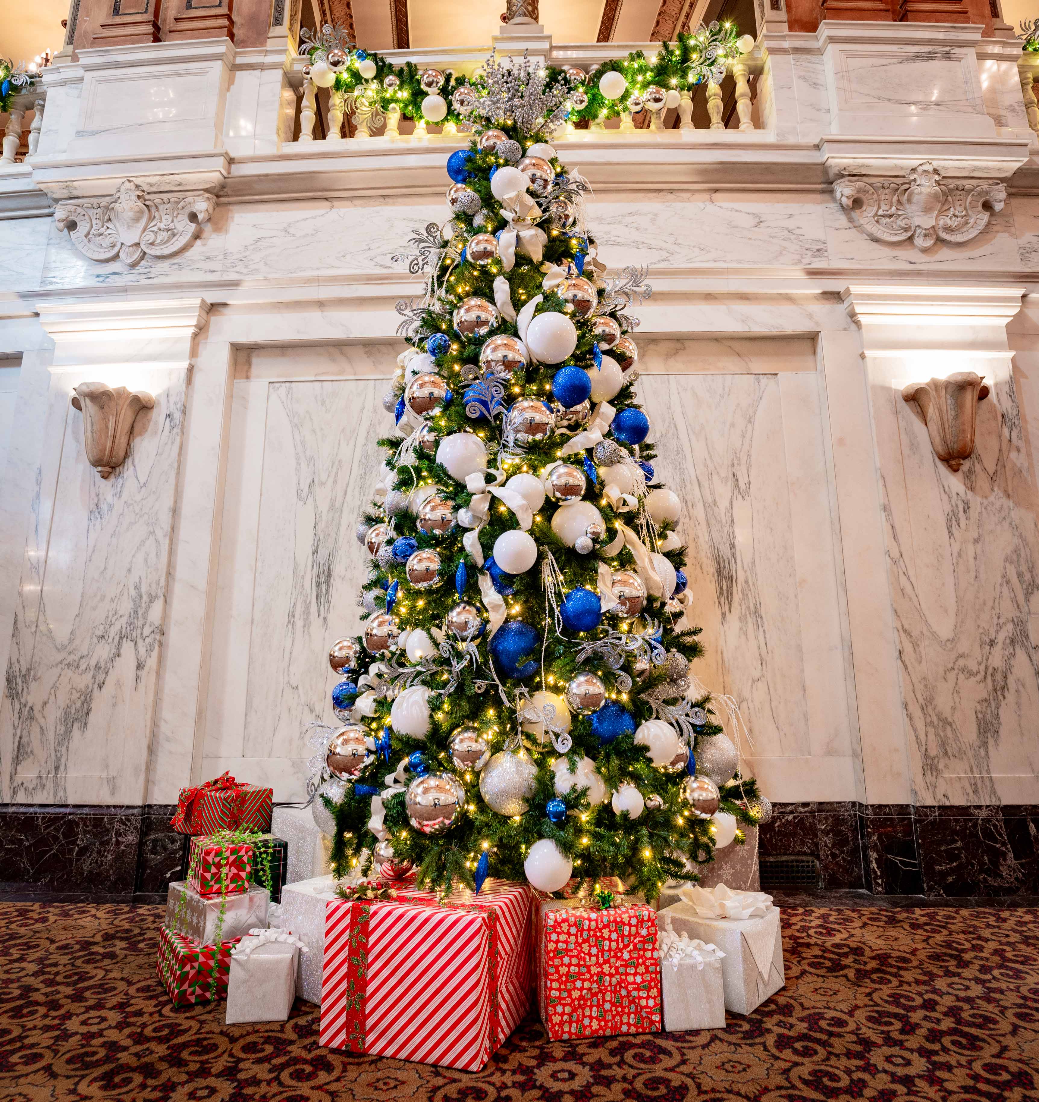 Ornate theater interior decorated with an illuminated Christmas tree in an HLI portfolio photograph
