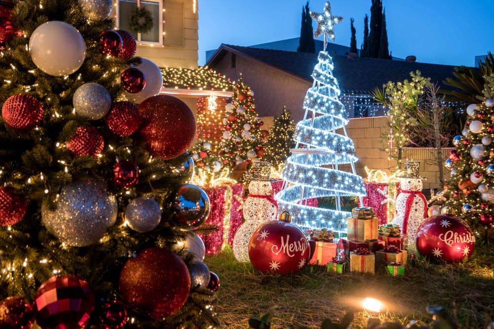 Layered red, white, and silver ornaments in a large HLI residential holiday display