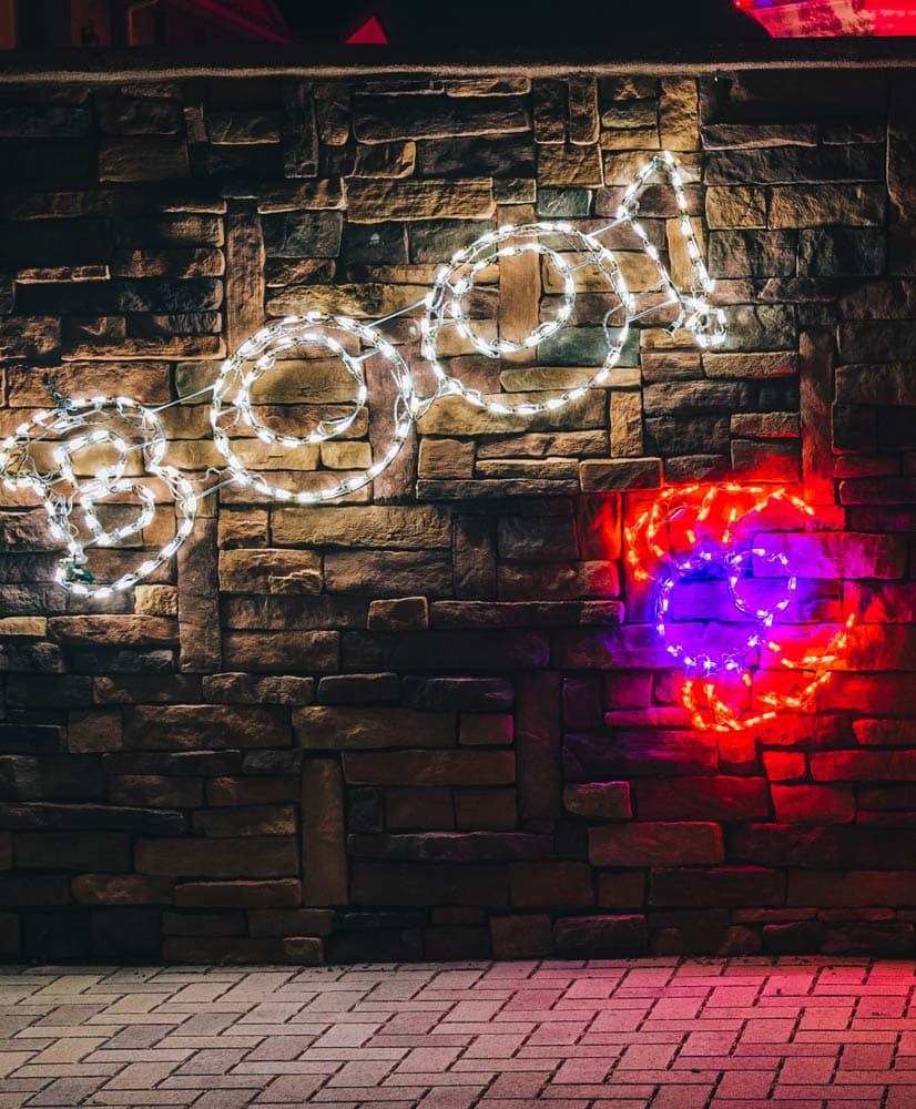 Custom illuminated holiday décor mounted against stone in an HLI project photograph
