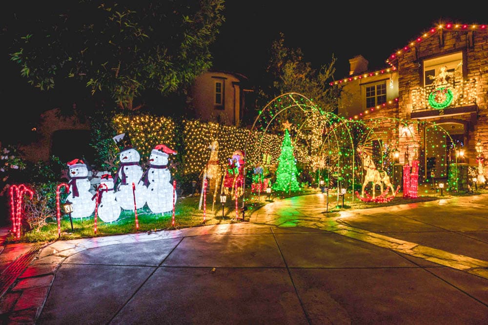 Large custom residential Christmas display with illuminated arches, figures, trees, and rooflines in the HLI portfolio